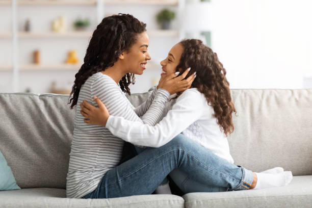 istock Loving black mother touching her happy daughter face 1319052888