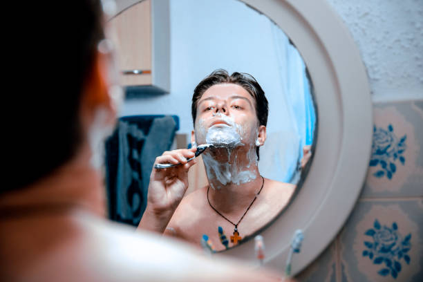 istock Handsome Man Shaving His Face In The Morning 1319054424