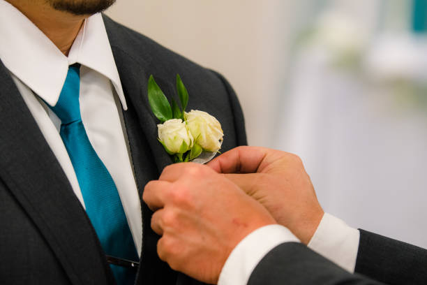 istock Groom attaches boutonniere 1319054955