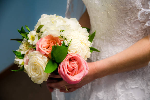 istock Bride holding rose bouquet 1319055059