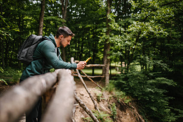 istock Man looking at the map on the wooden bridge 1319055235