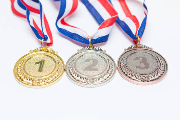 Gold, silver and bronze sports achievement medals for first, second and third place, on a white background. Olympic games and sport concept. stock photo