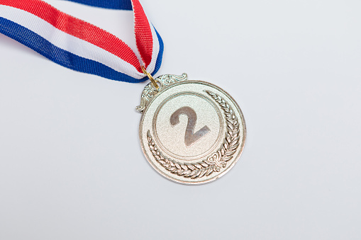 Silver medal of sporting achievement for the second classified, on white background. Olympic games and sport concept