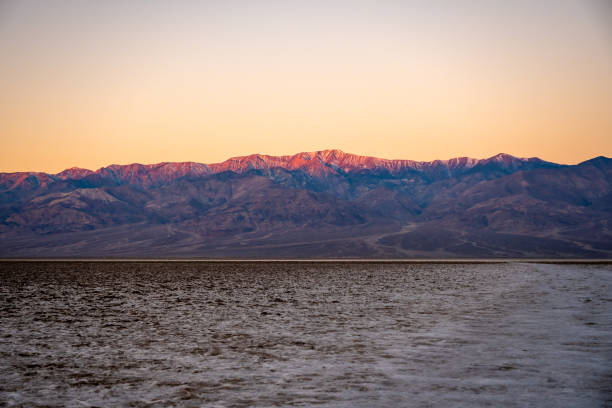 istock First Light Hits the Mountain Tops Above Badwater Basin 1319060022