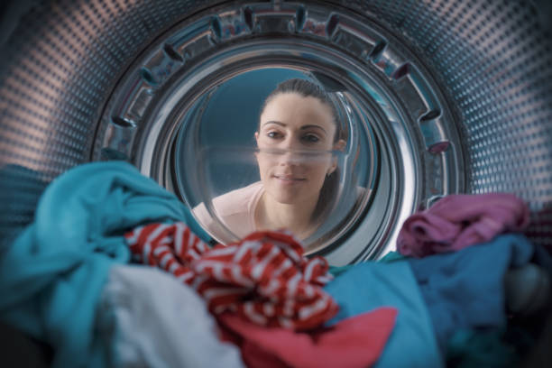 istock Woman looking inside the washing machine 1319060367