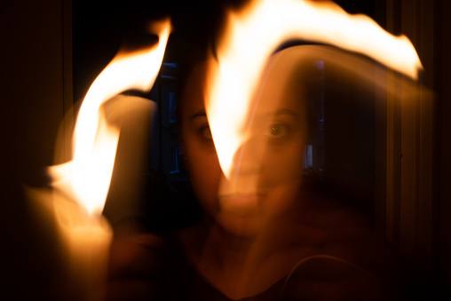Woman in horror. Playing with fire.