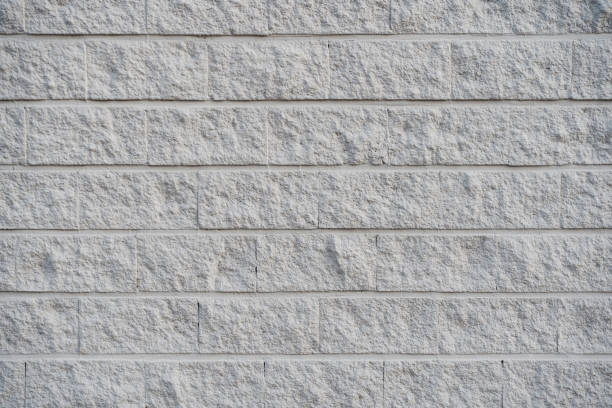 A gray and rough concrete brick wall. Concrete block wall background and texture.