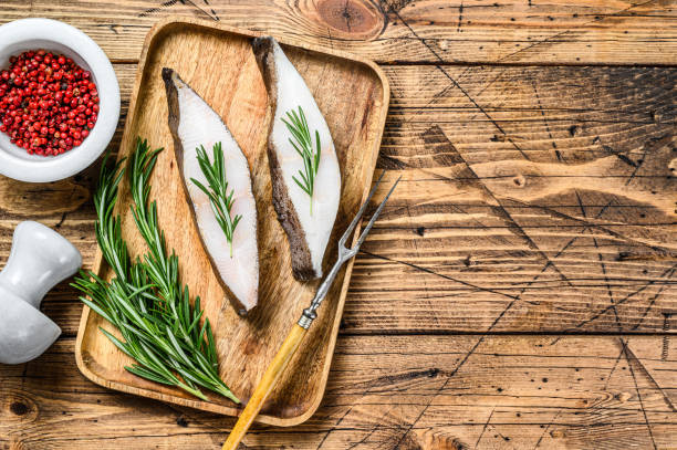 istock Raw halibut saltwater fish steak. wooden background. Top view. Copy space 1319063034