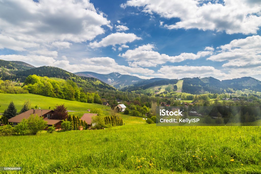 Mountain village Malenovice and Lysa hora Marvelous landscape with blue sky and clouds. Lysa hora summit in the background - Moravian-Silesian Beskydy Czech Republic Stock Photo
