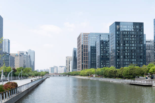 istock Modern office buildings on the riverbank under blue sky and white clouds 1319066851