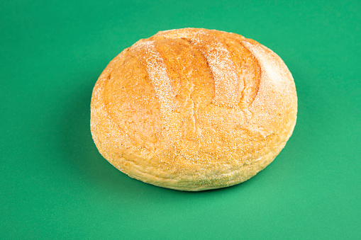 Fresh homemade bread on green background