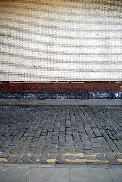 istock Urban background UK - White brick wall with sidewalk 131907225