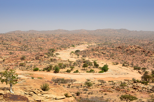 Laas Geel, Maroodi Jeex region, Somaliland, Somalia: area with landscape defined by a semi-arid climate, known for the cave paintings located in a red granite rock outcrop - meander in a wadi / oued, a dry riverbed for a temporary / seasonal river.