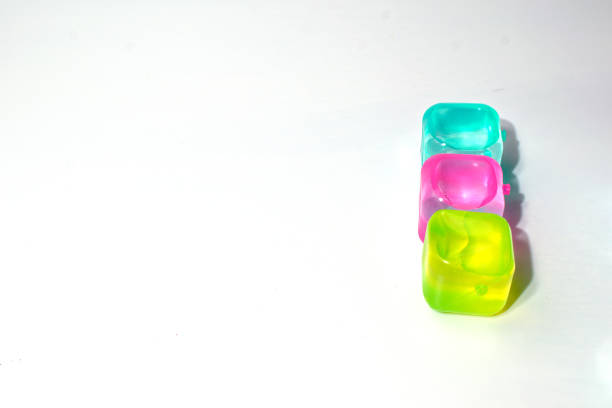 Artificial ice cubes of different colors made of plastic. Isolate.