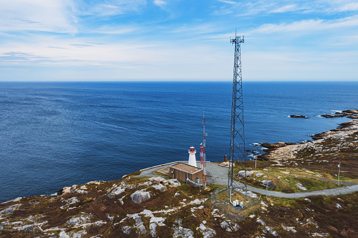 Aerial drone view of a radio/cellular tower on the Atlantic coast.