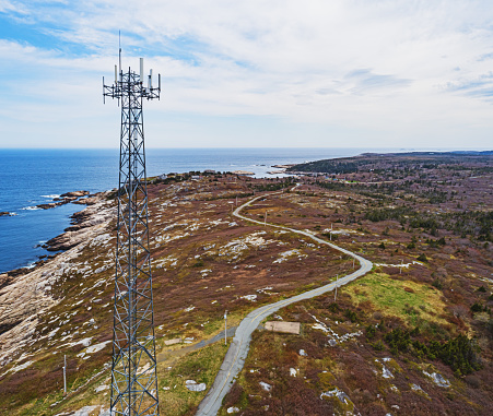 Aerial drone view of a radio/cellular tower on the Atlantic coast.