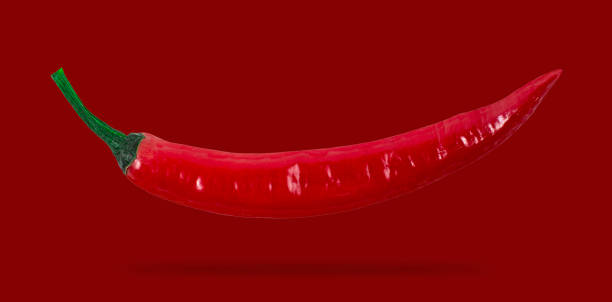 istock Red hot chili pepper soars on red background isolated 1319081408