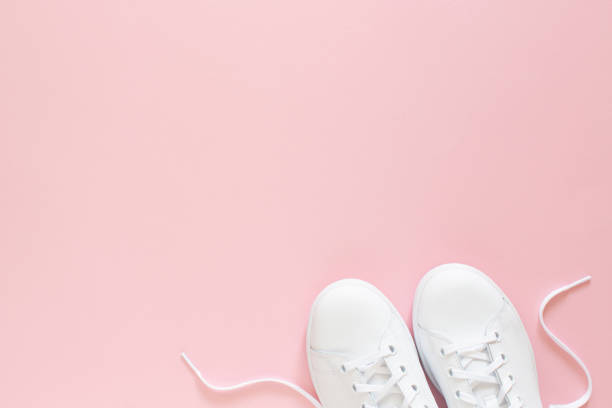 istock All white sneakers on pink background. Top view,flat lay 1319082394