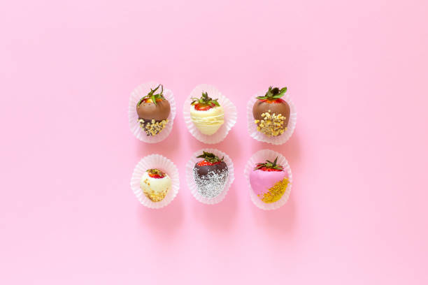 istock Strawberries covered with chocolate on a pink background. Flat lay fruits composition 1319082510