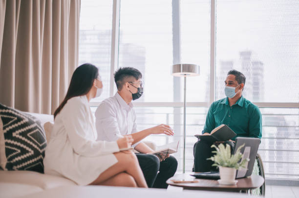 istock asian indian male white collar worker with disability sitting on wheelchair having discussion with his colleague at business lounge 1319083576