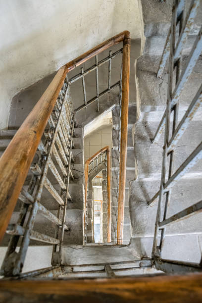 istock Old spiral staircase with wooden railing 1319086486
