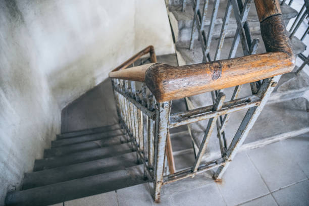 istock Old spiral staircase with wooden railing 1319086522