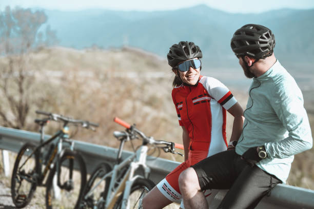 istock Happy Cyclist Couple Sitting On Road Side Together 1319087246