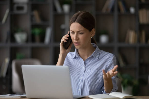 istock Worried young lady manager calling client to discuss contract breach 1319087302