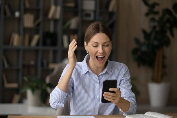 istock Overjoyed female reading unbelievable good news in message on cell 1319087305