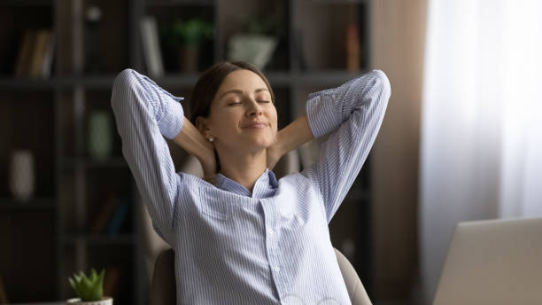 istock Peaceful young woman relax by desk take break in work 1319087398