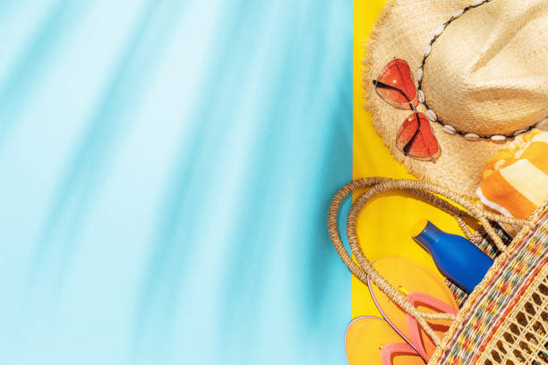 istock Straw hat, sunglasses and other beach accessories on a colored background with copy space 1319088768