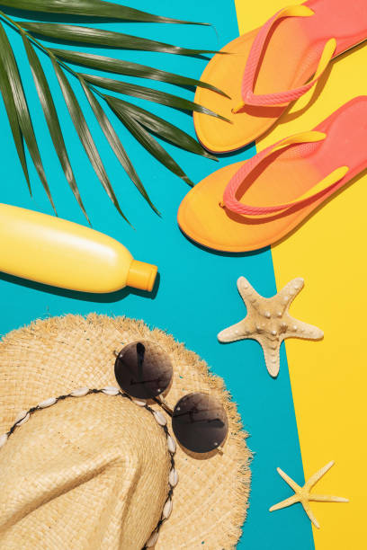 istock Flat composition with beach holiday accessories and palm leaf on colored background, summer background. 1319088810