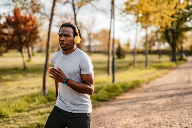 istock Athlete man running in public park 1319090723