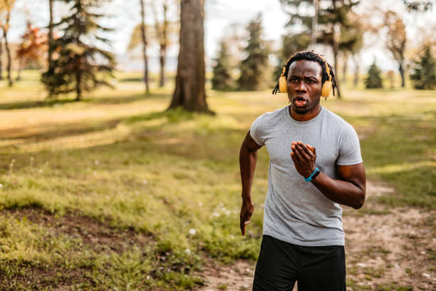 istock Athlete man running in public park 1319090767