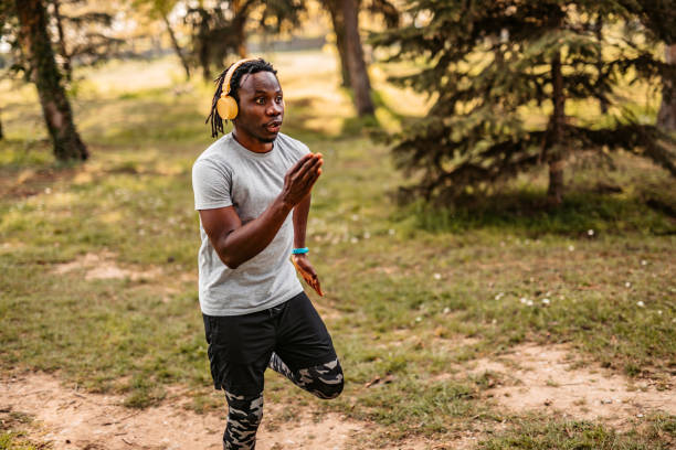 istock Athlete man running in public park 1319090898