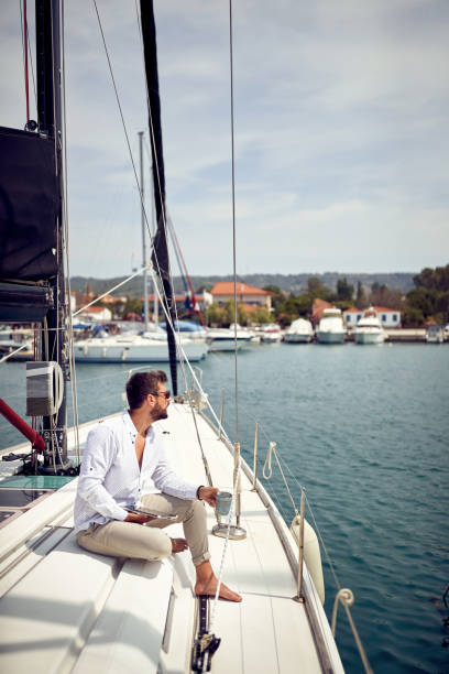 istock A young man is enjoying a view while sitting on a yacht at sea and using a tablet. Summer, sea, vacation 1319091114