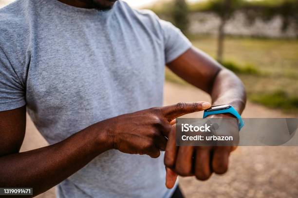 Athlete Check Fitness Tracker After Training In Nature Stock Photo - Download Image Now