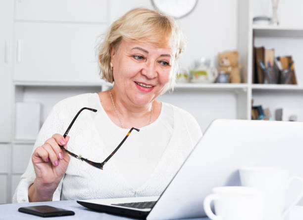 istock Mature woman with laptop 1319091485