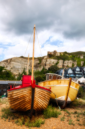 Old, wooden fishing boats on the shore at Hastings, England