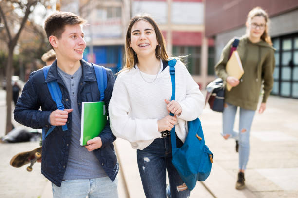 istock Smiling teenagers walking outside after lessons 1319094476