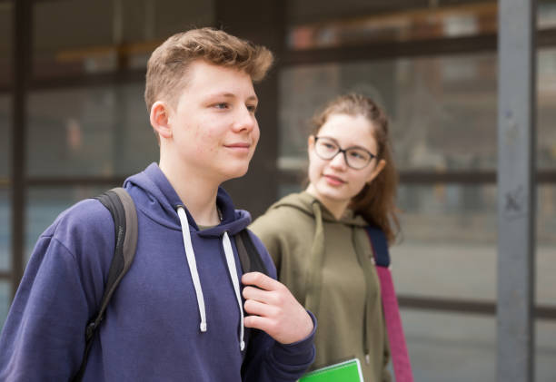 istock Smiling teenagers walking outside after lessons 1319094503