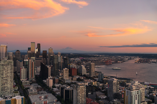 Aerial footage above Seattle, Washington, USA, the evening sun casting deep shadows on the city.
