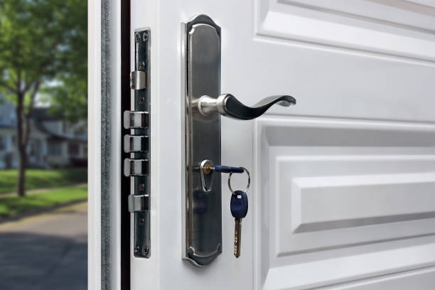 Opened door of a family home. Close-up of the lock with your keys on an armored front door. Security. Opened door of a family home. Close-up of the lock with your keys on an armored front door. Security. latch stock pictures, royalty-free photos & images