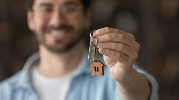 istock Close up focus on keys, satisfied man excited by relocation 1319095699