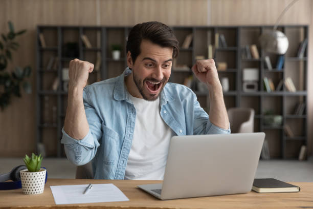 istock Overjoyed surprised businessman looking at laptop screen, celebrating success 1319095970