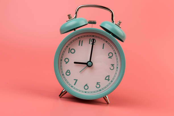 istock Old clock isolated on a pink background with space for text. Concept of time 1319097551