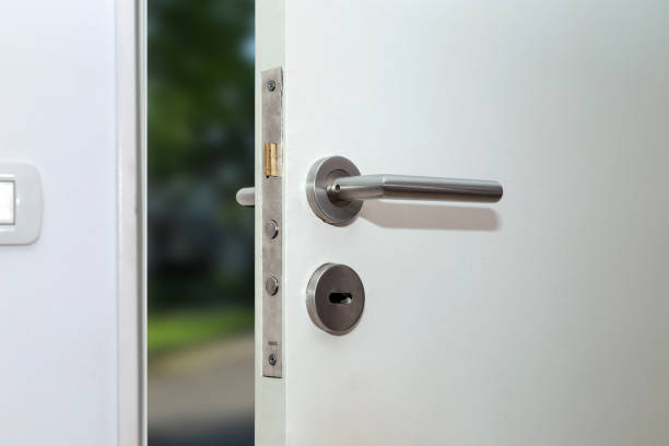 Opened door of a family home. Close-up of the lock with your keys on an armored front door. Security. Opened door of a family home. Close-up of the lock with your keys on an armored front door. Security. door lock stock pictures, royalty-free photos & images