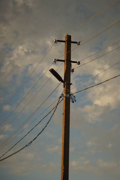 istock Electric tower in evening sunset sky with clouds 1319097866
