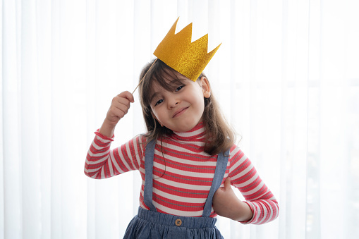 Cute little girl with a paper accessories