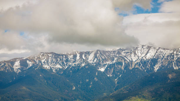 istock Heavy clouds over the Bucegi mountains in Romania during a spring day, as seen from the hills of Pestera village. 1319099202